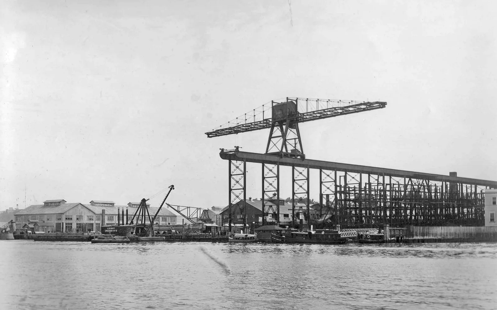 Mare Island Naval Shipyard waterfront with naval vessels moored at dock, 1913